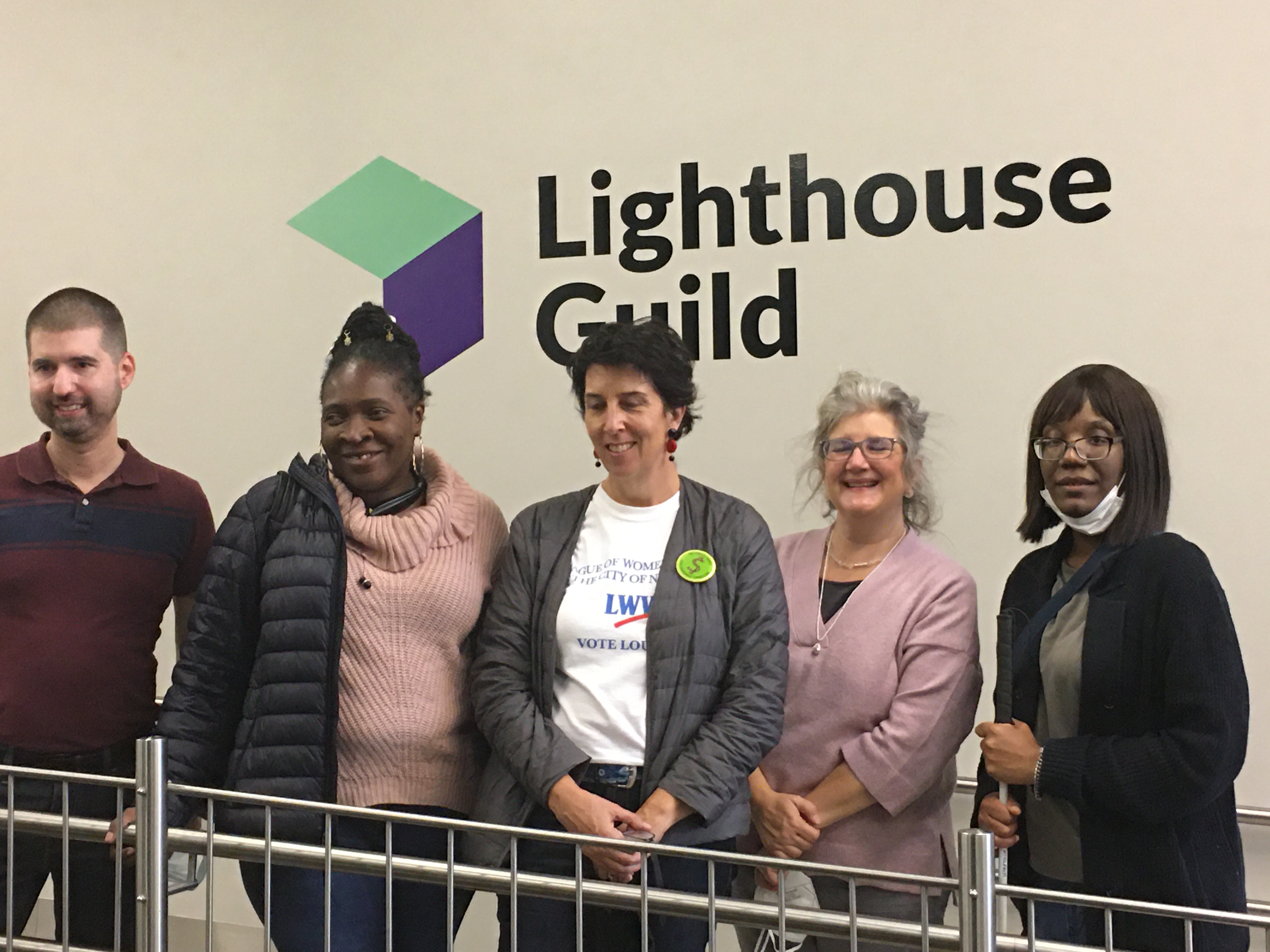 Photo: One man and four women stand in front of a white wall with the words Lighthouse Guild. Pictured from left to right: Jayden Mitchell, Rasheta Bunting, Danielle Mowery, Deborah Brodheim, and Yasmin Campbell. Please note: Kathy Collins also represented our chapter at the event.